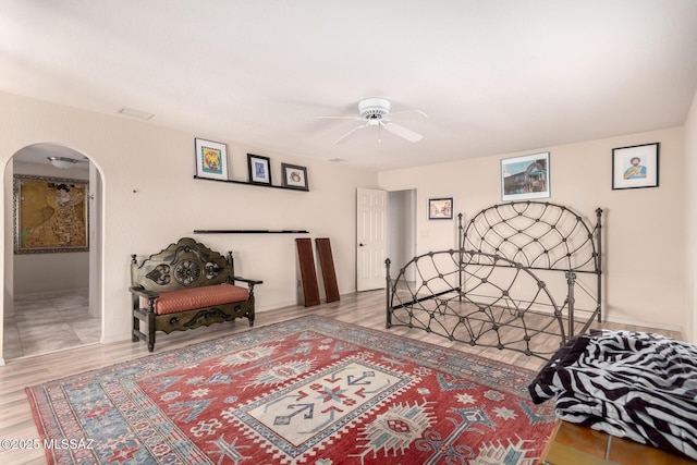 3740 W Placita Fantasia, Tucson, AZ 85745 - bedroom with arched walkways, a ceiling fan, and wood finished floors