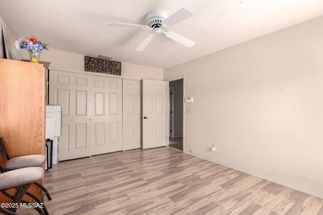 3740 W Placita Fantasia, Tucson, AZ 85745 - unfurnished bedroom with light wood-type flooring, baseboards, a closet, and ceiling fan