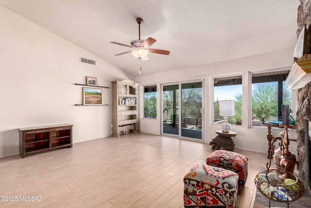3740 W Placita Fantasia, Tucson, AZ 85745 - living area with ceiling fan, healthy amount of natural light, vaulted ceiling, light wood-style flooring, and a textured ceiling