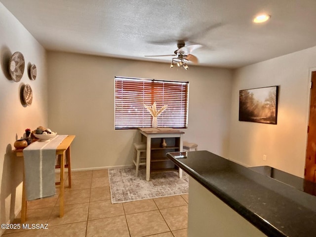 9756 E 32nd St, Tucson, AZ 85748 - dining area with ceiling fan, light tile patterned flooring, and baseboards