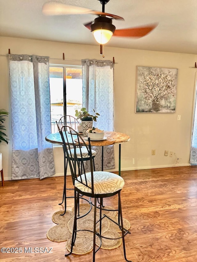 9756 E 32nd St, Tucson, AZ 85748 - dining space featuring light wood-type flooring, ceiling fan, and baseboards