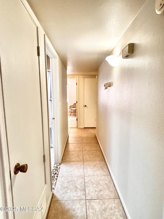 9756 E 32nd St, Tucson, AZ 85748 - corridor with light tile patterned floors and baseboards