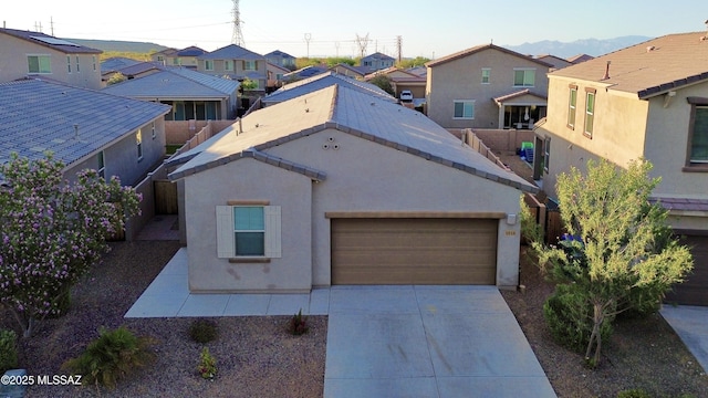 1016 W Calle Nicoya, Sahuarita, AZ 85629 - view of front facade featuring a residential view, concrete driveway, stucco siding, an attached garage, and a tiled roof
