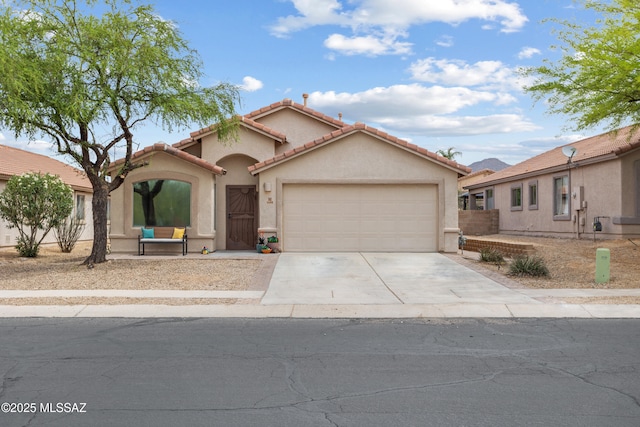 5466 W Dove Mountain Park Rd, Marana, AZ 85658 - mediterranean / spanish-style house with a garage, driveway, stucco siding, and a tile roof