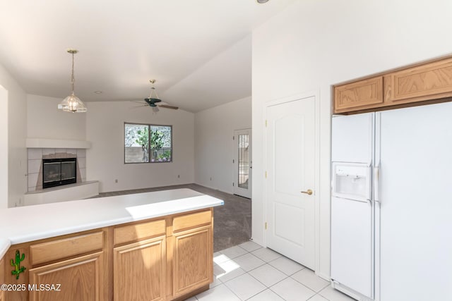 3252 W Flowering Cactus Ct, Tucson, AZ 85745 - kitchen featuring white fridge with ice dispenser, light tile patterned floors, open floor plan, a tiled fireplace, and a ceiling fan