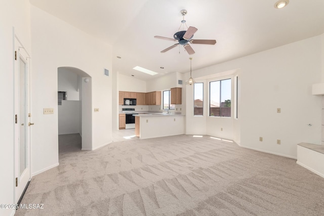 3252 W Flowering Cactus Ct, Tucson, AZ 85745 - unfurnished living room with arched walkways, ceiling fan, light carpet, baseboards, and a sink
