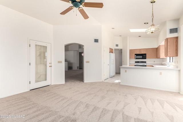 3252 W Flowering Cactus Ct, Tucson, AZ 85745 - kitchen featuring black microwave, range with electric cooktop, arched walkways, white fridge with ice dispenser, and a high ceiling