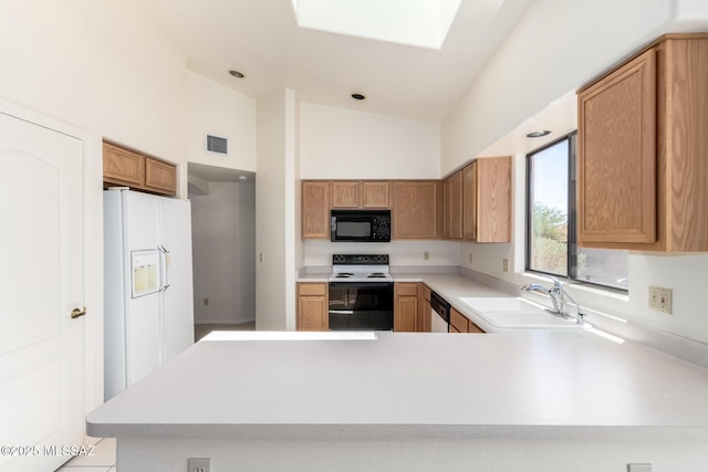 3252 W Flowering Cactus Ct, Tucson, AZ 85745 - kitchen featuring range with electric stovetop, black microwave, a sink, light countertops, and a towering ceiling