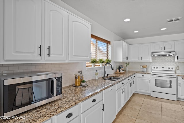 6945 S Wingbow Dr, Tucson, AZ 85756 - kitchen with white appliances, under cabinet range hood, a sink, light stone countertops, and light tile patterned floors