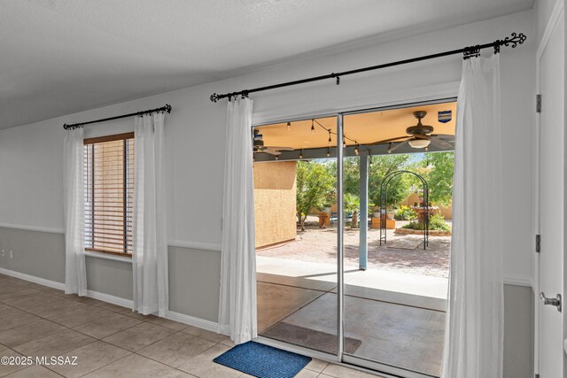 6945 S Wingbow Dr, Tucson, AZ 85756 - doorway with ceiling fan, tile patterned flooring, and baseboards
