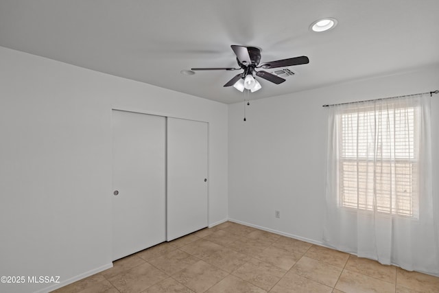 6945 S Wingbow Dr, Tucson, AZ 85756 - unfurnished bedroom featuring a closet, recessed lighting, ceiling fan, baseboards, and light tile patterned floors