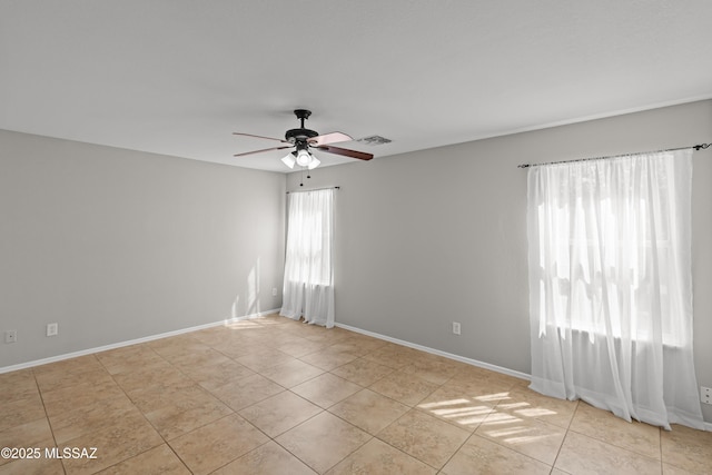 6945 S Wingbow Dr, Tucson, AZ 85756 - unfurnished room with ceiling fan, light tile patterned floors, and baseboards