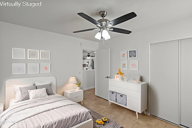 6945 S Wingbow Dr, Tucson, AZ 85756 - bedroom featuring light tile patterned floors, a ceiling fan, and a closet