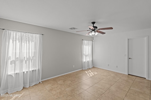 6945 S Wingbow Dr, Tucson, AZ 85756 - unfurnished room with ceiling fan, light tile patterned floors, and baseboards