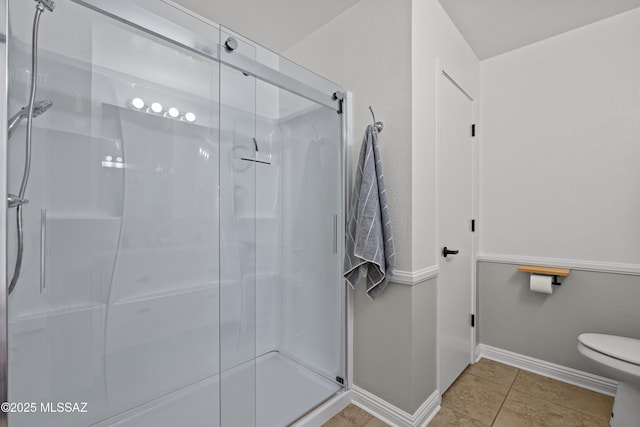 6945 S Wingbow Dr, Tucson, AZ 85756 - full bathroom with a shower stall, toilet, baseboards, and tile patterned floors