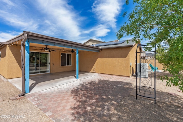 6945 S Wingbow Dr, Tucson, AZ 85756 - rear view of property with a ceiling fan, stucco siding, solar panels, and a patio area