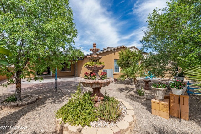 6945 S Wingbow Dr, Tucson, AZ 85756 - view of front of home featuring stucco siding and a patio