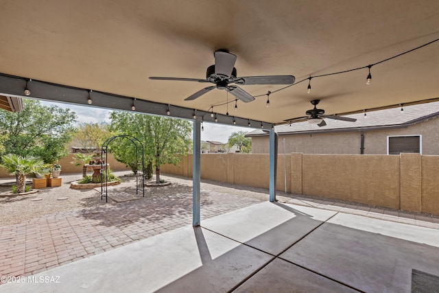 6945 S Wingbow Dr, Tucson, AZ 85756 - fenced backyard featuring a ceiling fan and a patio