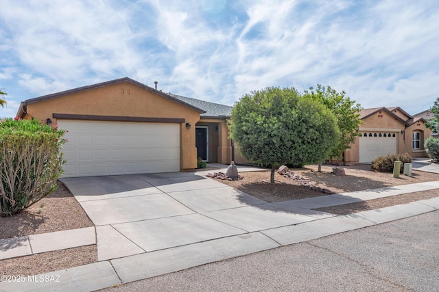 6945 S Wingbow Dr, Tucson, AZ 85756 - ranch-style house with stucco siding, a garage, and concrete driveway