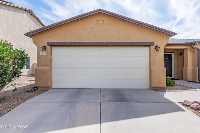 6945 S Wingbow Dr, Tucson, AZ 85756 - view of front facade with concrete driveway, stucco siding, and a garage