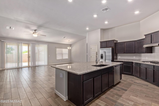 854 S Willis Ave, Vail, AZ 85641 - kitchen featuring appliances with stainless steel finishes, open floor plan, a ceiling fan, dark brown cabinets, and light wood finished floors