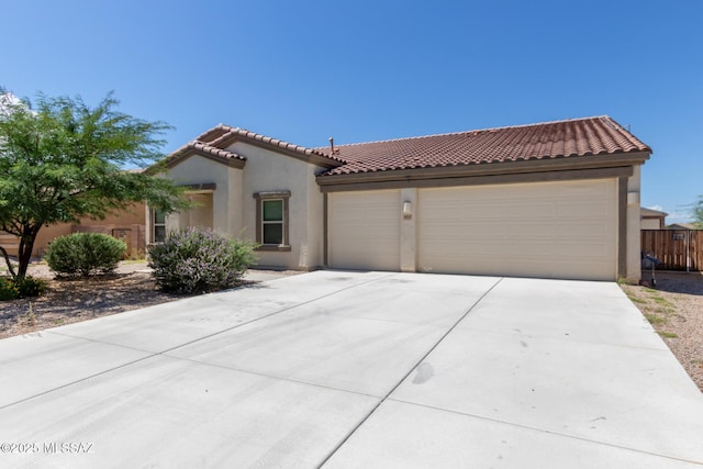 854 S Willis Ave, Vail, AZ 85641 - mediterranean / spanish house featuring stucco siding, an attached garage, a tiled roof, and concrete driveway