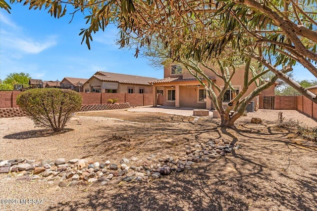 7441 E Sycamore Park Blvd, Tucson, AZ 85756 - rear view of house featuring a tiled roof, stucco siding, a fenced backyard, and a patio