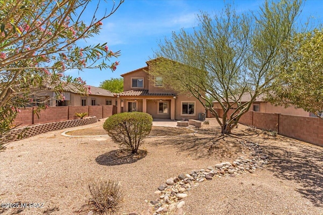 7441 E Sycamore Park Blvd, Tucson, AZ 85756 - rear view of house featuring a tile roof, a fenced backyard, stucco siding, and a patio area