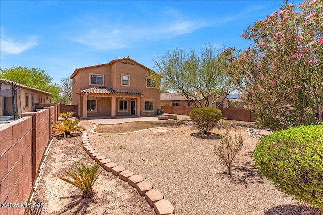 7441 E Sycamore Park Blvd, Tucson, AZ 85756 - rear view of house featuring stucco siding, a fenced backyard, a patio area, and a tile roof
