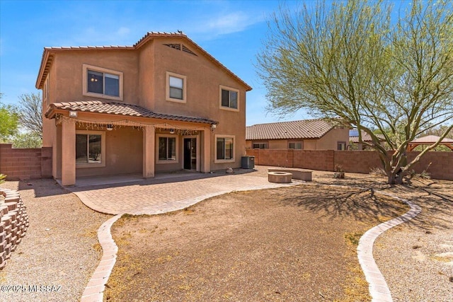 7441 E Sycamore Park Blvd, Tucson, AZ 85756 - back of property with an outdoor fire pit, a tiled roof, stucco siding, and a fenced backyard