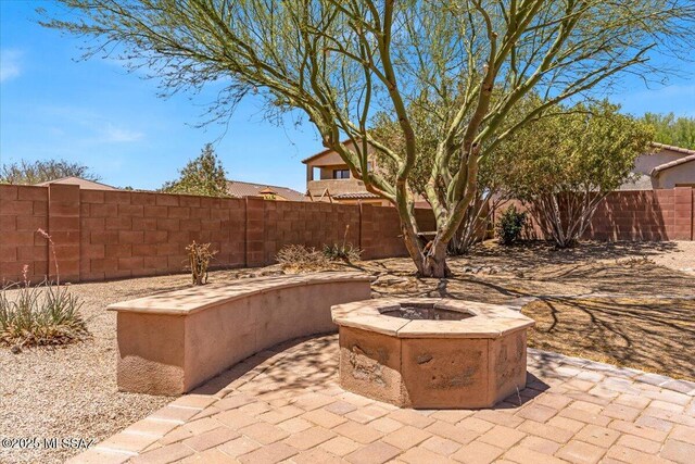 7441 E Sycamore Park Blvd, Tucson, AZ 85756 - fenced backyard with a fire pit and a patio