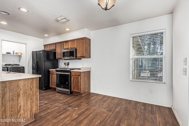 6399 S Sunrise Valley Dr, Tucson, AZ 85706 - kitchen with appliances with stainless steel finishes, independent washer and dryer, dark wood finished floors, recessed lighting, and brown cabinetry