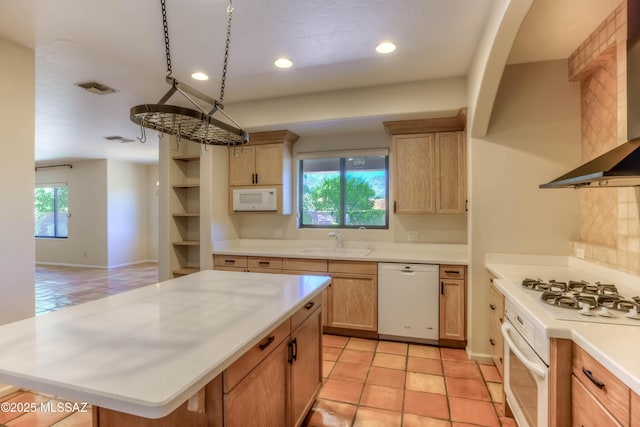 7275 E Vuelta Rancho Mesquite, Tucson, AZ 85715 - kitchen featuring white appliances, wall chimney range hood, a sink, light countertops, and recessed lighting
