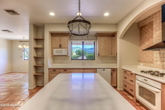 7275 E Vuelta Rancho Mesquite, Tucson, AZ 85715 - kitchen featuring white appliances, wall chimney range hood, light brown cabinets, light countertops, and recessed lighting
