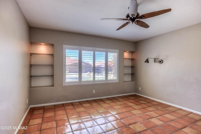7275 E Vuelta Rancho Mesquite, Tucson, AZ 85715 - spare room featuring built in shelves, a ceiling fan, baseboards, and light tile patterned floors