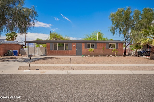 7909 E Beverly St, Tucson, AZ 85710 - ranch-style home with brick siding, driveway, and a carport