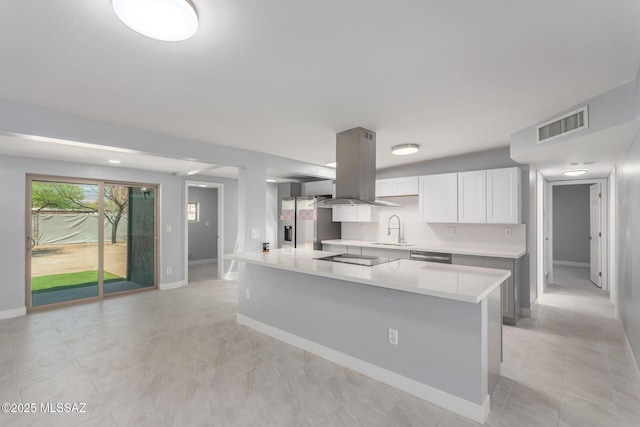 7909 E Beverly St, Tucson, AZ 85710 - kitchen featuring a sink, island exhaust hood, light countertops, baseboards, and white cabinetry