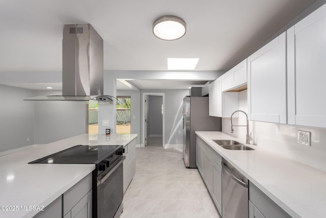 7909 E Beverly St, Tucson, AZ 85710 - kitchen featuring a sink, appliances with stainless steel finishes, island range hood, and light countertops