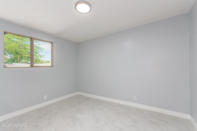 7909 E Beverly St, Tucson, AZ 85710 - empty room featuring baseboards
