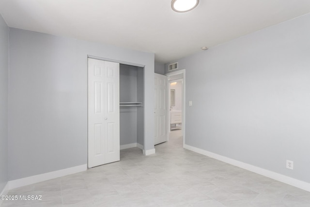 7909 E Beverly St, Tucson, AZ 85710 - unfurnished bedroom featuring a closet and baseboards