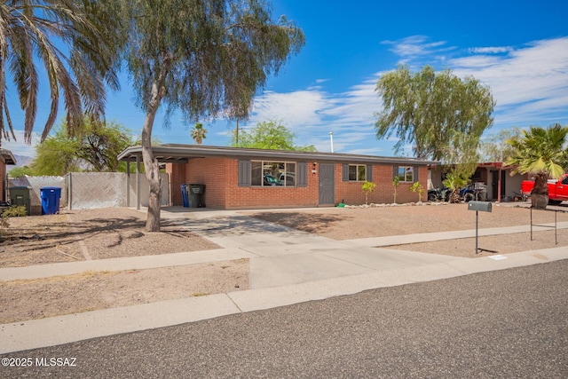 7909 E Beverly St, Tucson, AZ 85710 - ranch-style house featuring brick siding, concrete driveway, and a carport