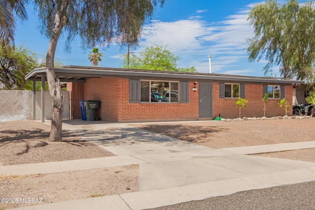 7909 E Beverly St, Tucson, AZ 85710 - single story home with brick siding, concrete driveway, and a carport