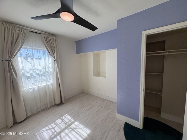 140 W 27th St, Tucson, AZ 85713 - unfurnished bedroom featuring a closet, baseboards, ceiling fan, and light wood finished floors