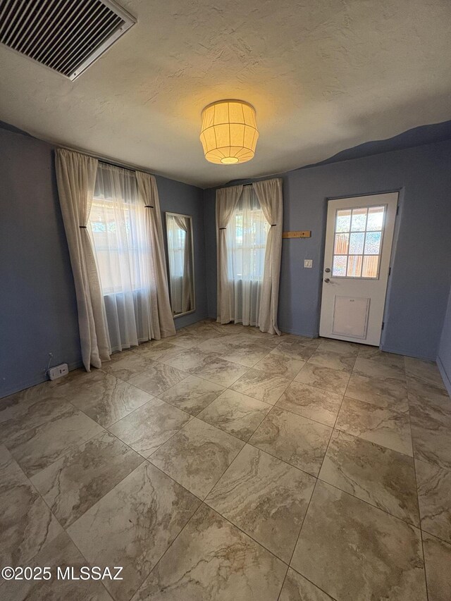 140 W 27th St, Tucson, AZ 85713 - spare room featuring a textured ceiling