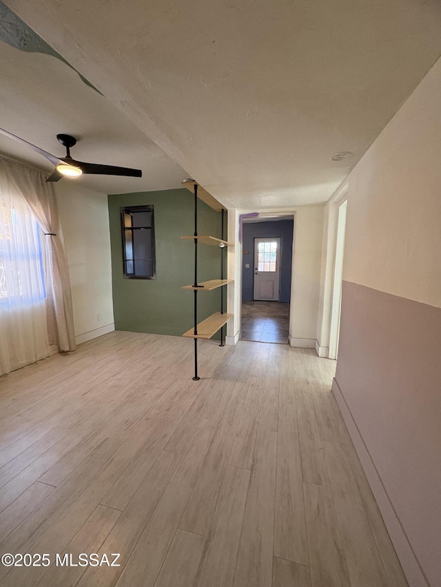 140 W 27th St, Tucson, AZ 85713 - spare room featuring wood finished floors, a ceiling fan, and baseboards