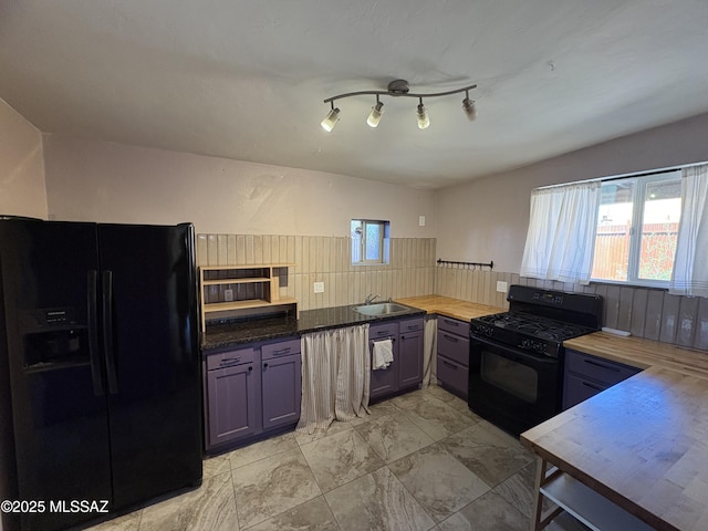140 W 27th St, Tucson, AZ 85713 - kitchen with black appliances, a sink, butcher block counters, backsplash, and light marble finish floors