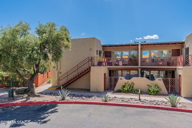 6255 N Camino Pimeria Alta Unit 22, Tucson, AZ 85718 - view of front of property featuring stucco siding, stairs, and a balcony