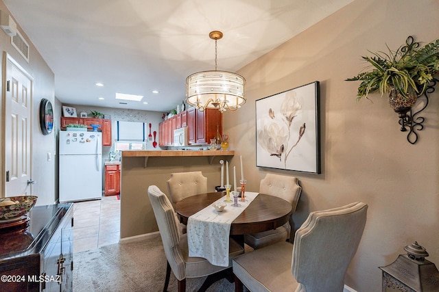 6255 N Camino Pimeria Alta Unit 22, Tucson, AZ 85718 - dining area featuring a chandelier, light colored carpet, and recessed lighting
