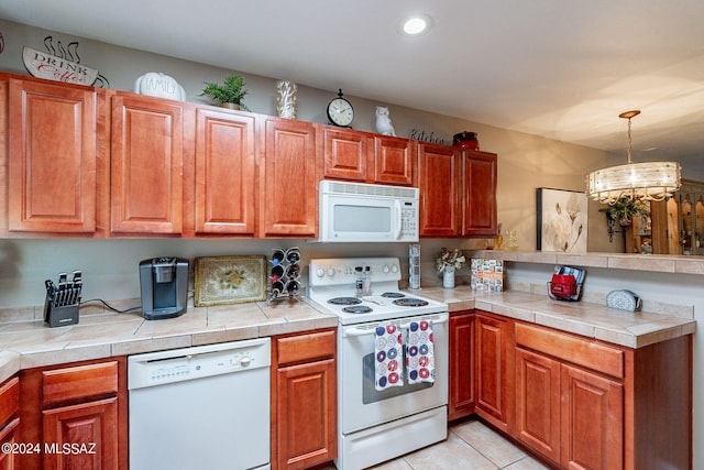 6255 N Camino Pimeria Alta Unit 22, Tucson, AZ 85718 - kitchen with white appliances, a peninsula, light countertops, pendant lighting, and recessed lighting