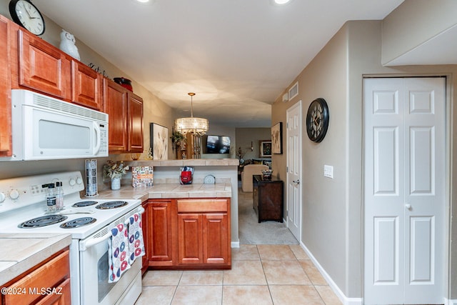 6255 N Camino Pimeria Alta Unit 22, Tucson, AZ 85718 - kitchen with white appliances, a peninsula, light tile patterned floors, and brown cabinetry